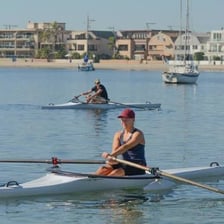 A person rowing a boat with an oar