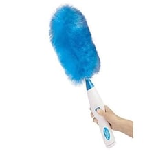A cleaner dusting a street or pavement area