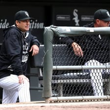 A baseball manager standing in a team dugout.