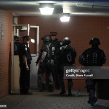 Police officers conducting a raid at a building