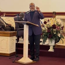 A pastor speaking to a congregation in a church