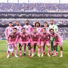 A football team of eleven players lined up on the pitch