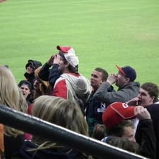 An audience reacting negatively to a performance by booing.