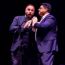 A male singer performing, representing a baritone voice
