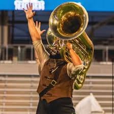 A musician playing a large brass tuba