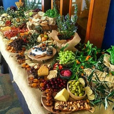 A table laid out with food for a large feast.