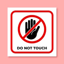 Raised hands making a clear do-not-touch gesture