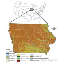 A view of Iowa farmland with a map of the state.