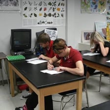 An examiner asking questions across a desk