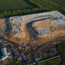 A landfill site containing layers of deposited rubbish