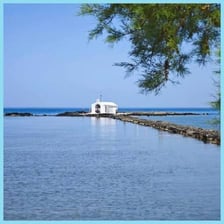 A church standing beside a coastal area of water