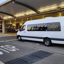 A taxi moving outside an airport terminal.