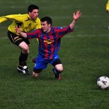 A football player theatrically going to ground