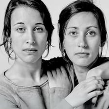 Two twins standing together.