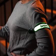 A person wearing a safety armband around the upper arm.