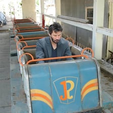 A roller-coaster rider with a gloomy expression