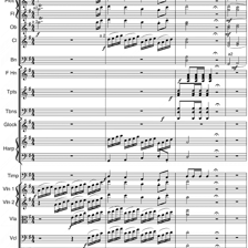 A person arranging orchestral music beside a musical score