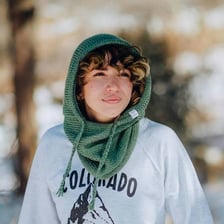 A hooded cowl garment covering the neck and head