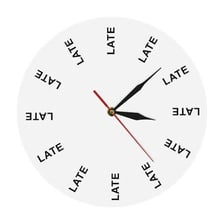 A person arriving at a meeting while checking a wall clock.