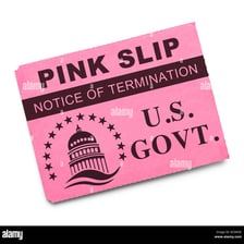 A pink paper notice representing a pink slip