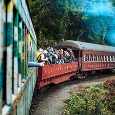 A passenger train traveling along railway tracks