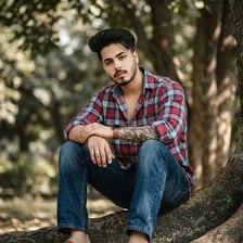 A casually dressed young man outdoors.
