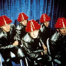 Devo performing or appearing in the music video for “Whip It.”