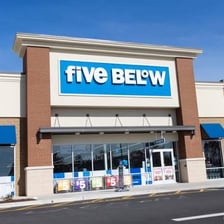 A high-five gesture alongside a Five Below retail storefront sign