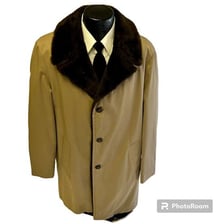A thick winter coat displayed on a mannequin.