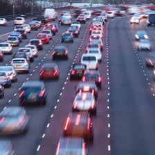Several passenger cars traveling on a road