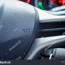 A vehicle horn mounted in a steering wheel