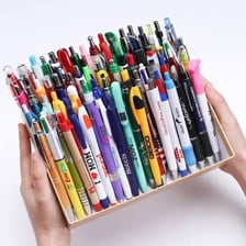 Several ballpoint pens used as writing instruments.