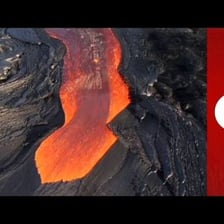 Molten lava flowing from a volcanic crater.