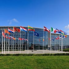 Flags outside NATO headquarters representing the military alliance.