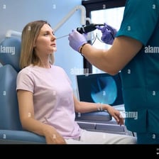 An ear, nose and throat doctor examining a patient's nose
