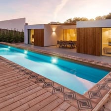 A swimming pool bordered by a flat deck surface