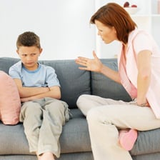 A child appearing to talk back during a conversation with a parent