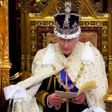 A monarch delivering a formal public speech