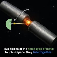 A welder joining two pieces of metal with a bright welding arc.