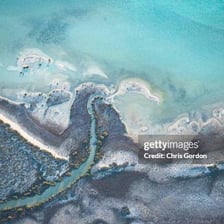 An aerial view of a narrow sea inlet cutting into the coastline.