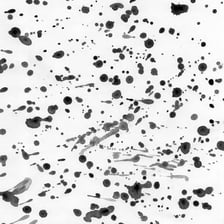 A dark ink blot on a sheet of white paper