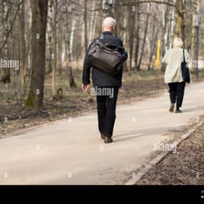 One person running after another in a park
