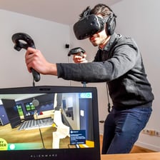 A person wearing a virtual-reality headset in an immersive simulated environment.