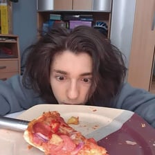 A person eating the last slice of a pizza.
