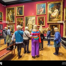 Visitors viewing artworks in a contemporary gallery.