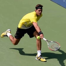 A tennis player sending the ball high over an opponent.