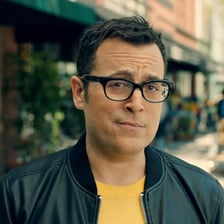 A man holding a mobile phone in a Verizon wireless commercial.