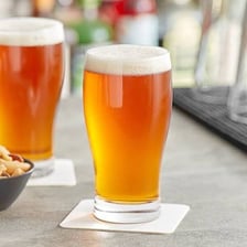 Pints of ale on a pub counter.