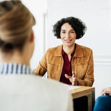 A person continuing a conversation after an interruption