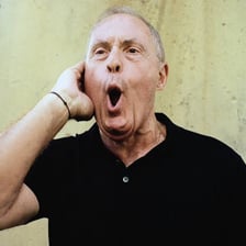A soccer commentator celebrating a goal in a stadium